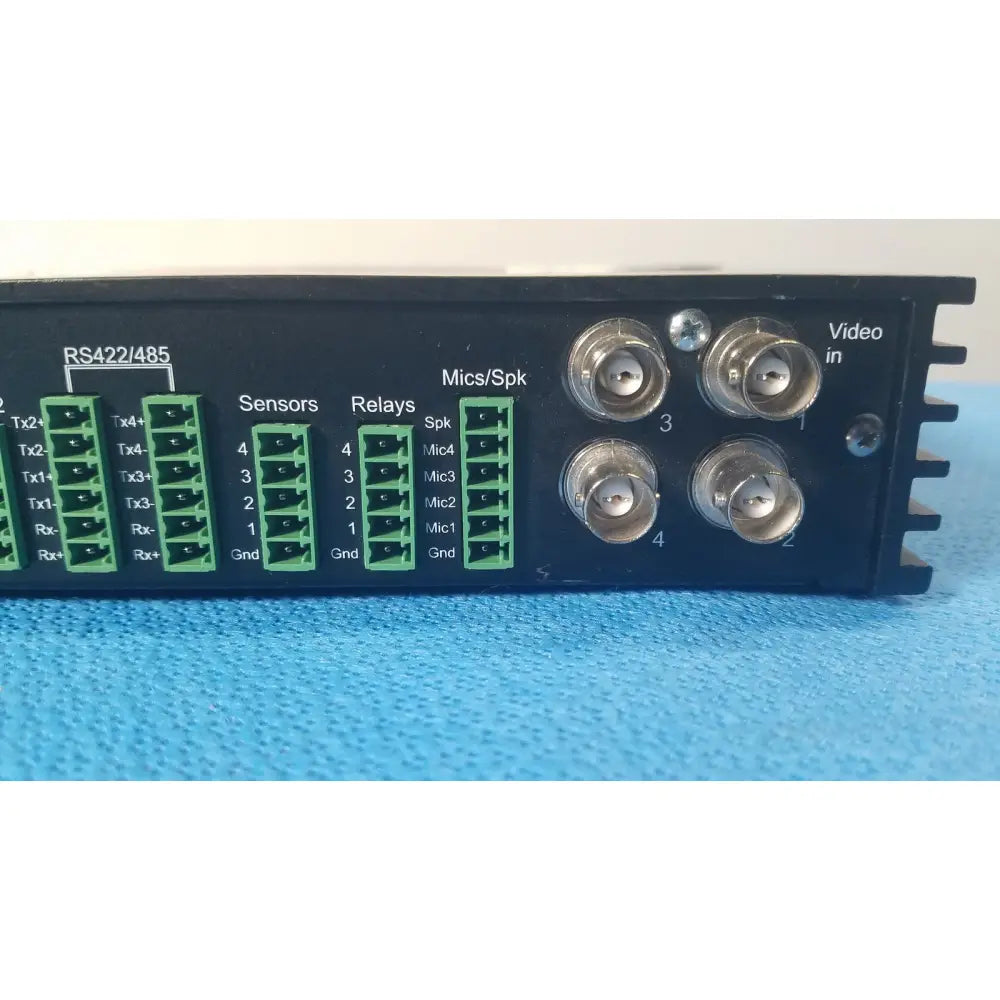 Back side of black VICONNet KTX-4 digital video encoder server with green terminal blocks and four silver bnc connectors for CCTV