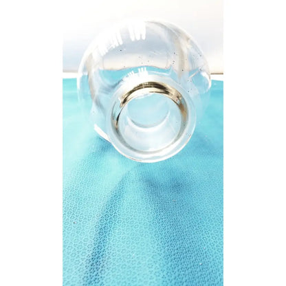 Vintage 9 inch clear glass bottle with embossed base and metallic silver rim, a timeless decorative piece