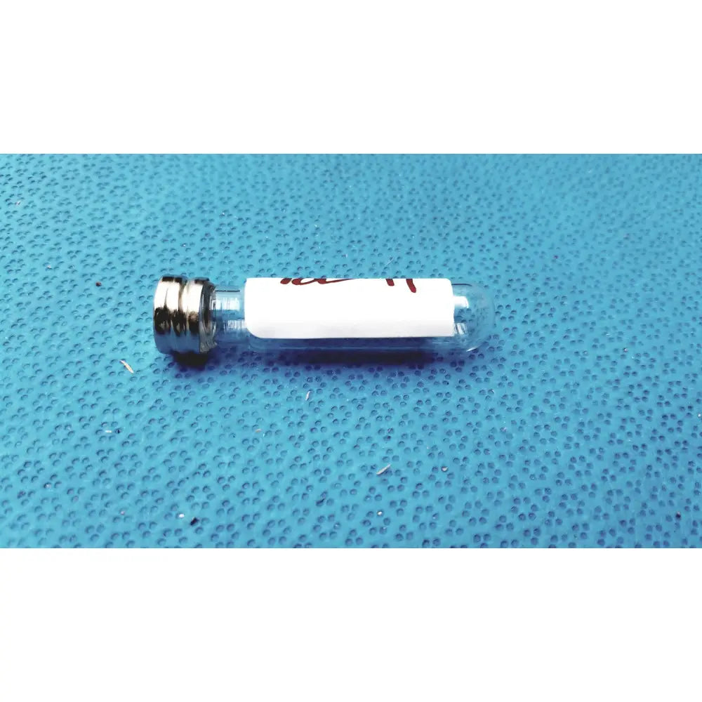 Clear glass vial with silver metal cap and white label for vintage johnson era dental floss original glass bottle