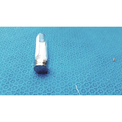 Clear glass vial with metallic cap and blue rubber seal containing white granular substance for vintage johnson era dental floss