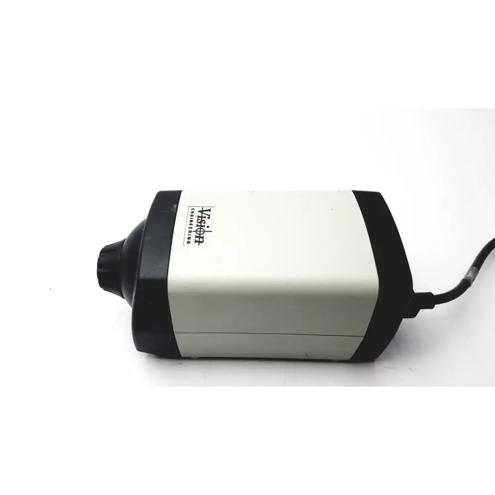 Black and white vision engineering microscope camera head with cylindrical matte body and visible power cord