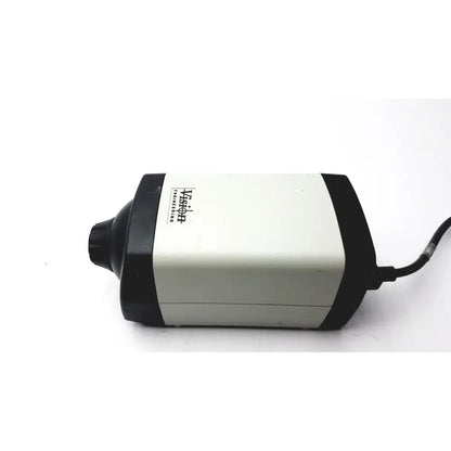 Black and white vision engineering microscope camera head with cylindrical matte body and visible power cord