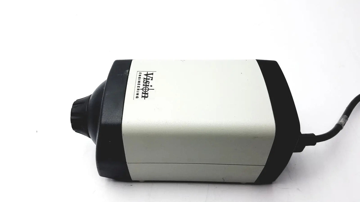Black and white vision engineering microscope camera head with cylindrical matte body and visible power cord