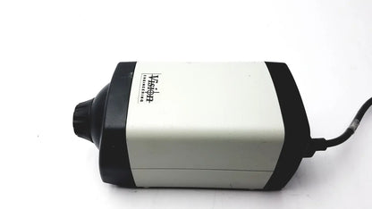 Black and white vision engineering microscope camera head with cylindrical matte body and visible power cord