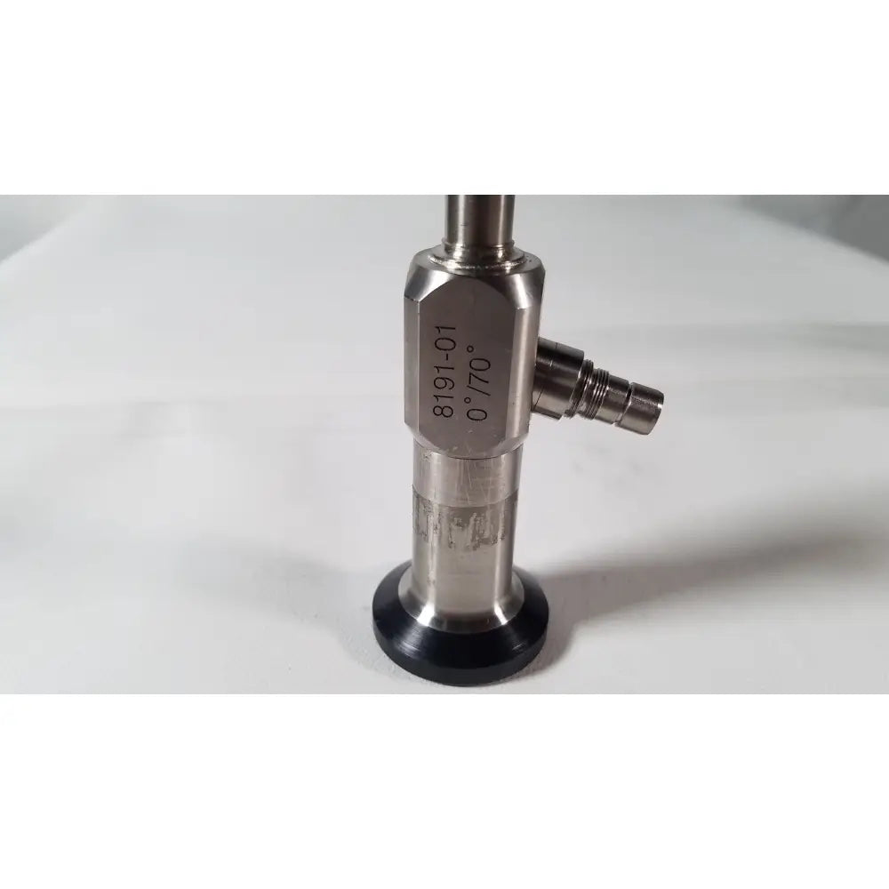 Stainless steel vista stereo laparoscopic surgery endoscope with engraved model number and black rubber base showing dents