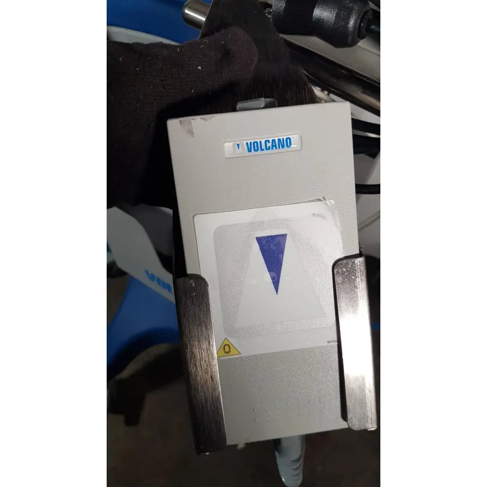 Gray Volcano brand industrial control panel with blue triangular symbol for Volcano S5 imaging operator’s manual reuse medical