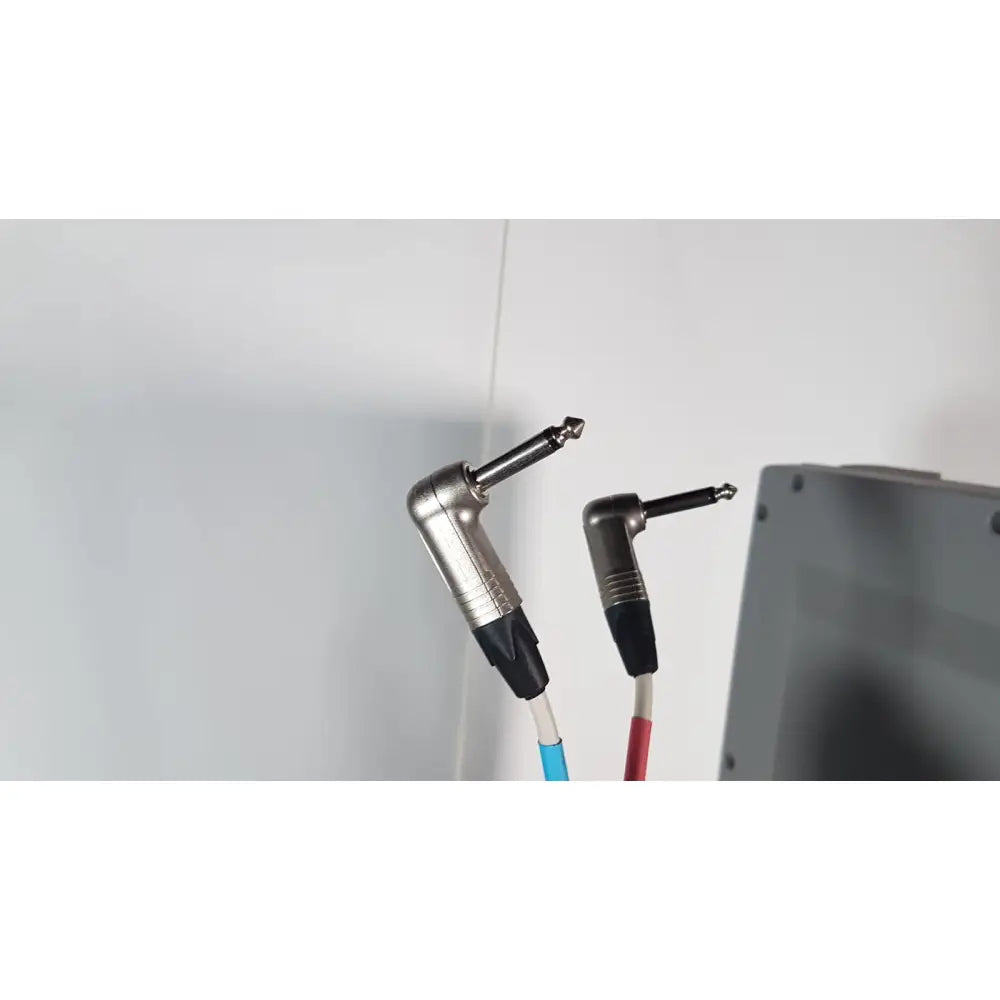 Silver and black angled guitar cable connectors with blue and red insulated cords in volcano s5 imaging operator’s manual reuse medical