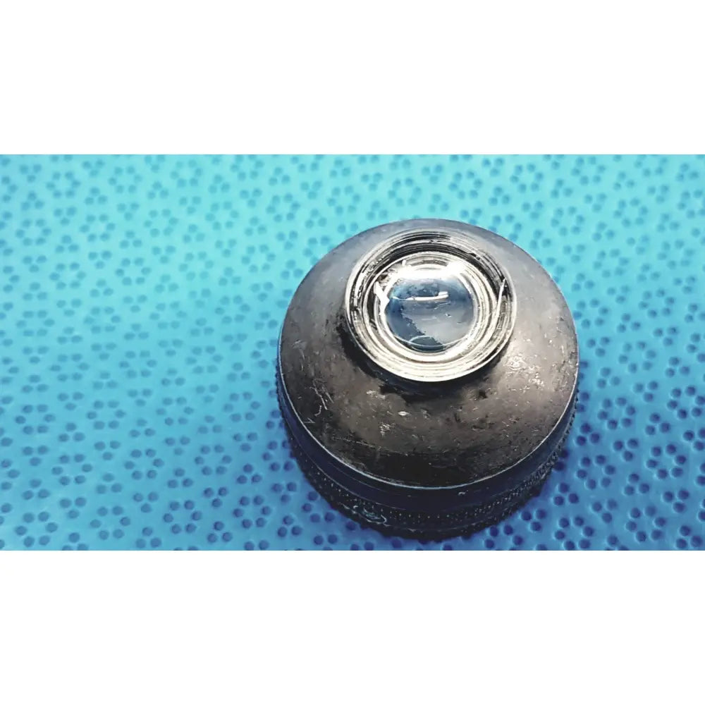 Black worn rubber lens cap with clear plastic insert for the back side of volk super quad 160 ophthalmic laser lens