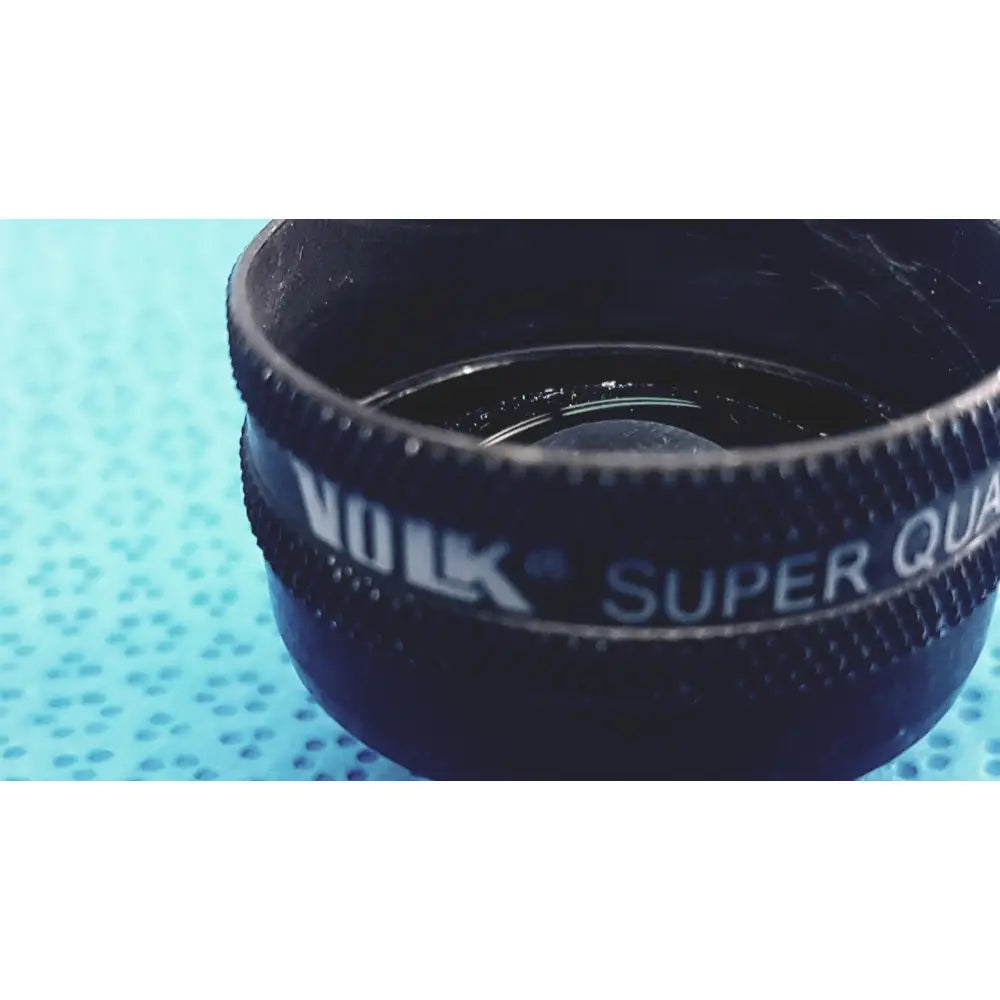 Black volk super quad ophthalmic laser lens attachment with textured grip and white lettering for precision use