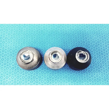 Three volk super quad ophthalmic laser lenses with metallic silver and black finishes featuring central glass elements