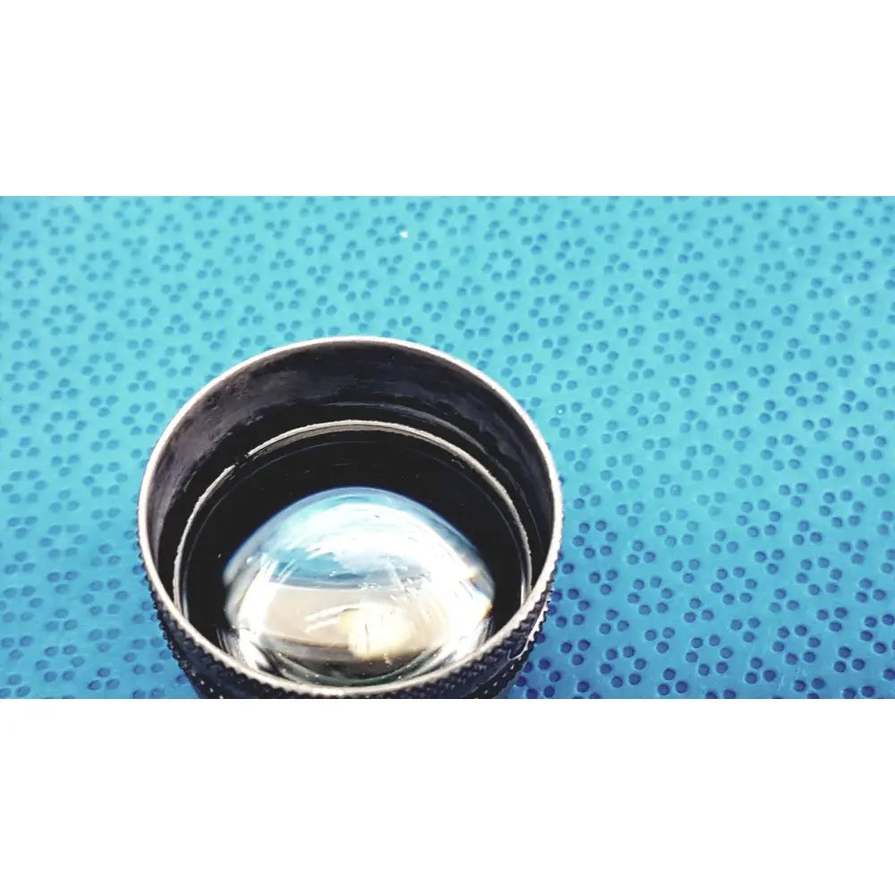 Black volk super quad 160 ophthalmic laser lens with clear reflective glass and textured outer ring for precision use