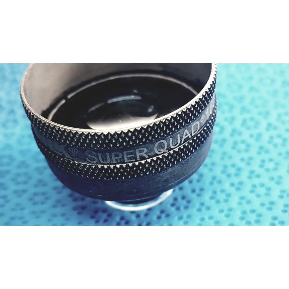 Black and silver volk super quad ophthalmic laser lens with textured grip ring for precise retinal treatment