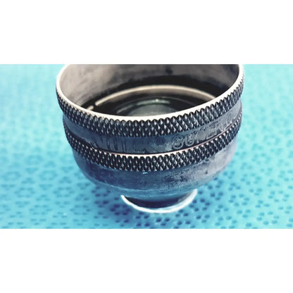 Vintage silver-toned volk super quad ophthalmic laser lens featuring textured knurled rings and engraved markings