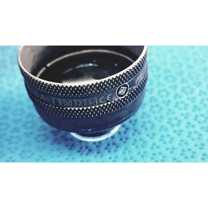 Black textured lens mount with silver metallic accents and engraved markings on volk super quad 160 ophthalmic laser lens