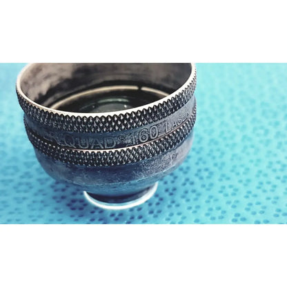 Black textured metal volk super quad 160 ophthalmic laser lens with engraved branding for precise laser treatments