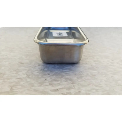 Rectangular vollrath 82830 stainless steel polished medical instrument tray with rounded corners and raised rim
