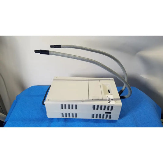 White rectangular Volpi Intralux 5000 fiber optic illuminator with dual flexible gray gooseneck hoses and side label