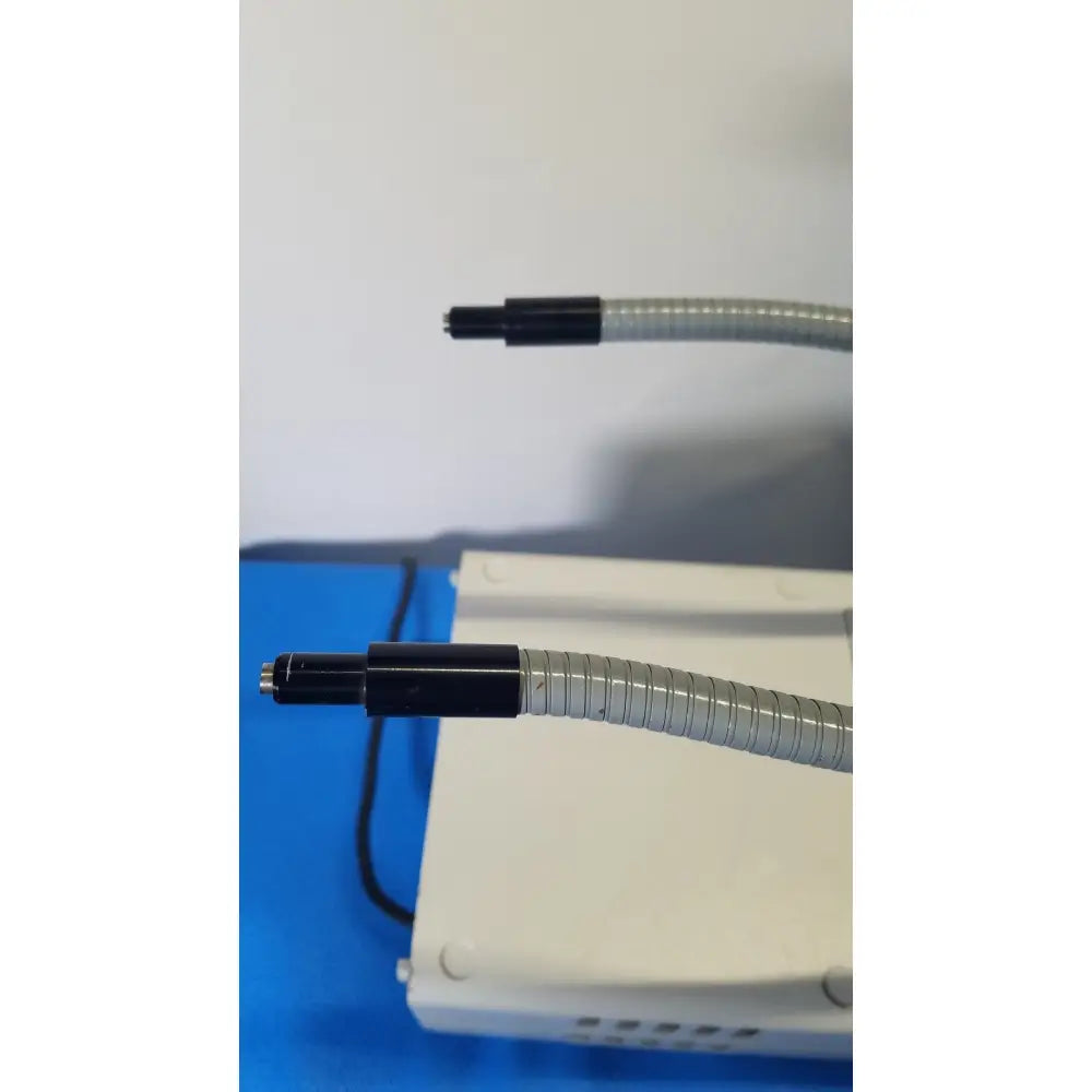 Two flexible gray corrugated tubes with black capped ends for volpi intralux 5000 fiber optic illuminator dual gooseneck