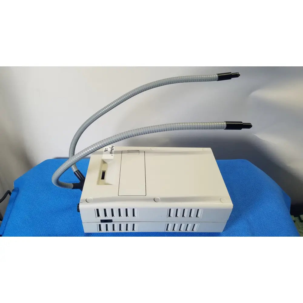 Beige volpi intralux 5000 fiber optic illuminator with dual gooseneck gray hoses for microscope light use