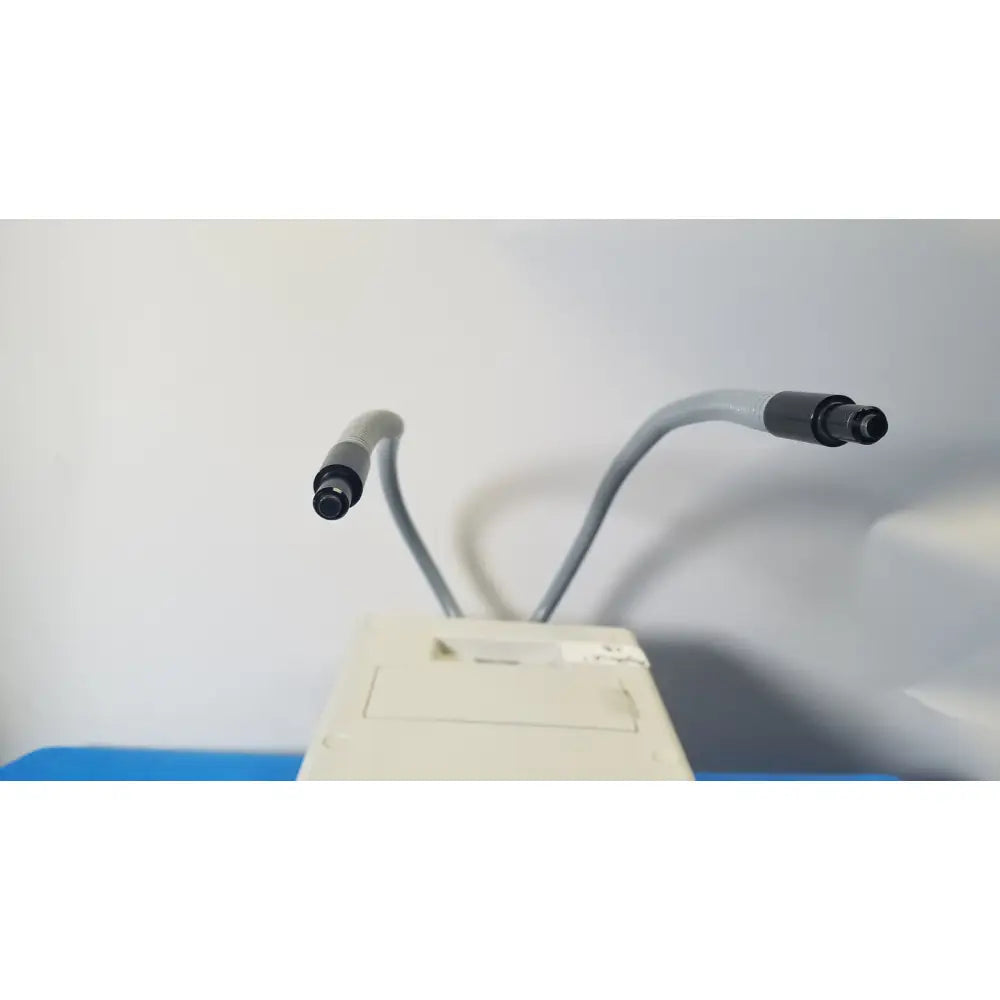 Beige fiber optic illuminator dual gooseneck with gray flexible arms and black connectors for microscope lighting