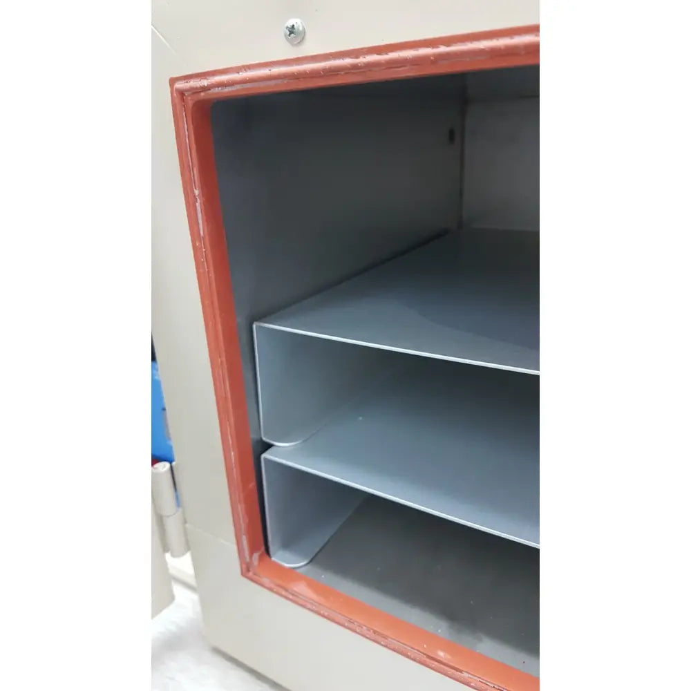 Beige metal vwr 1410 scientific vacuum oven with red-trimmed door and gray interior shelves for laboratory use