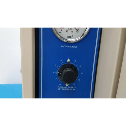 Blue vacuum gauge with silver dial and black knob on control panel of vwr 1410 scientific vacuum oven