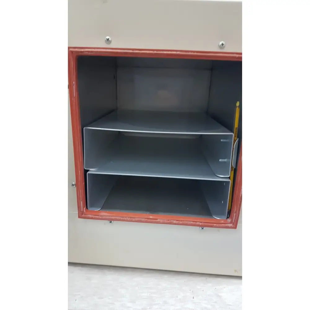Gray plastic document tray with two shelves inside red-framed door of VWR 1410 scientific vacuum oven laboratory unit