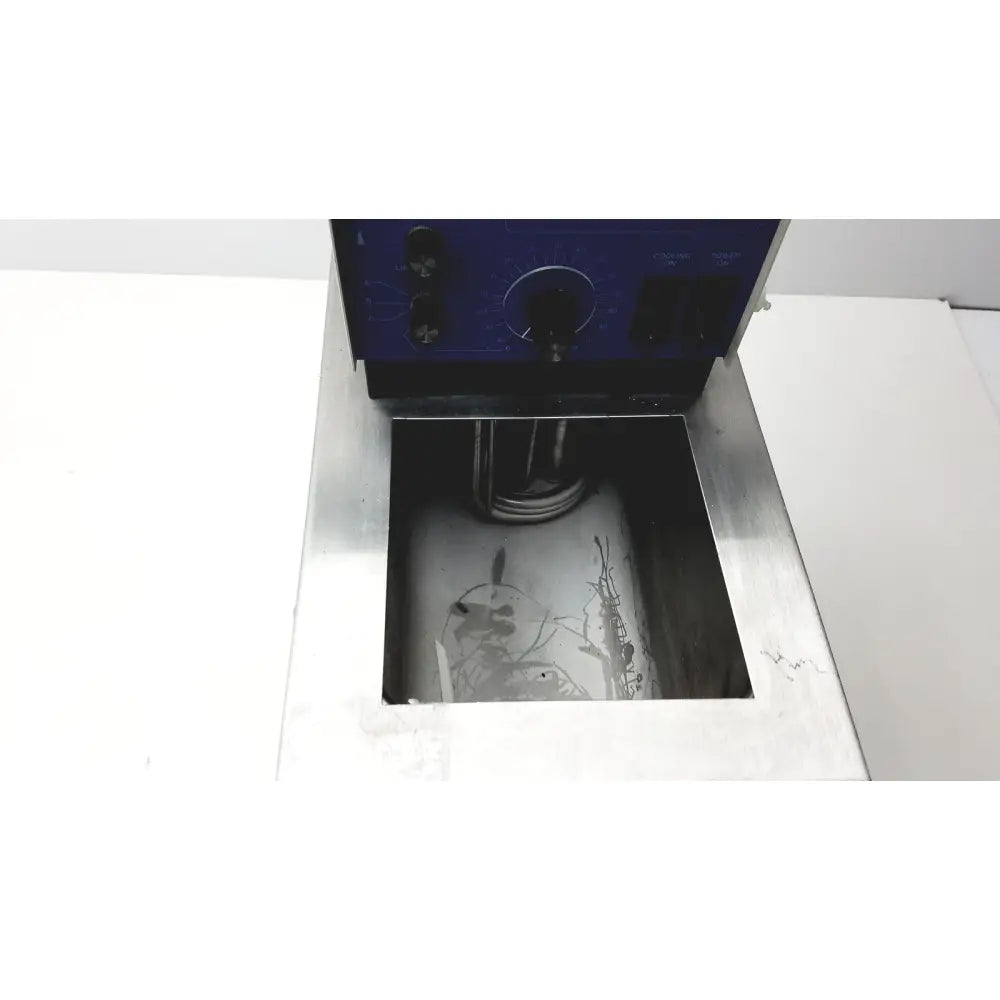 Blue control panel with black knobs on vwr scientific 1160 recirculating water bath above stainless steel tank