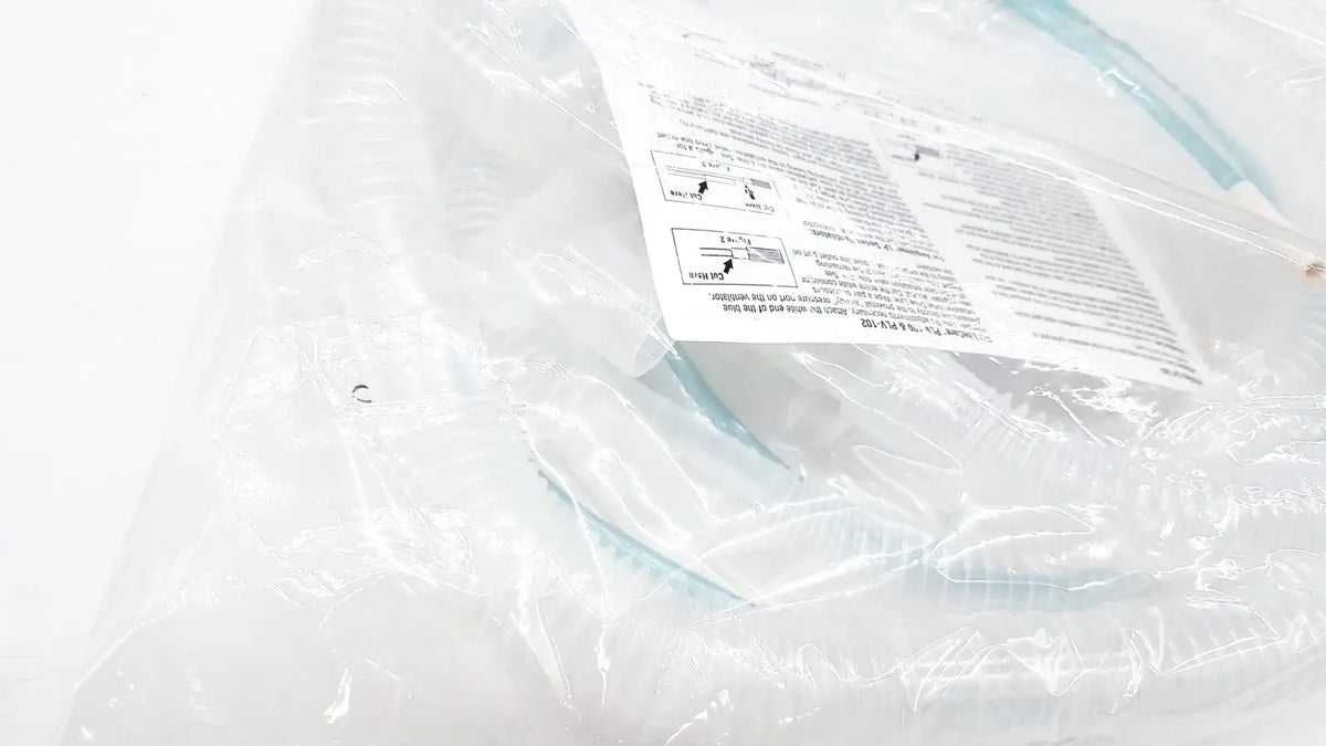 Light blue plastic nasal cannula in clear packaging with manual for vyaire airlife volume ventilator circuit