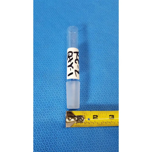 Clear plastic vial with white label and translucent cap in vycor 24/40 ground joint corning laboratory glassware adapter