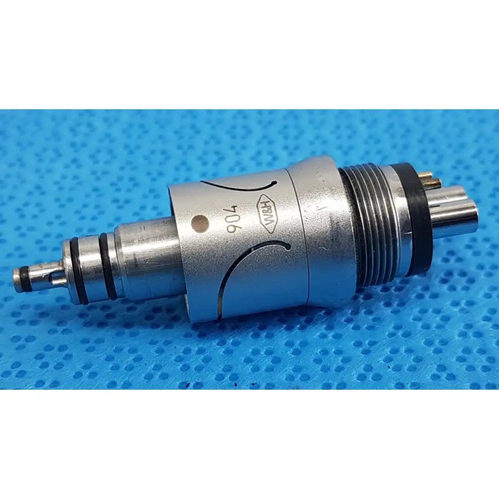 Silver metallic w&h handpiece coupler with black rubber seals and engraved markings for dental connector use