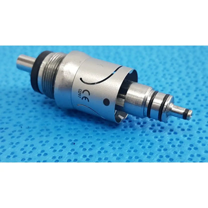 Silver w&h handpiece coupler with black rubber seals and engraved ce marking for dental connector use