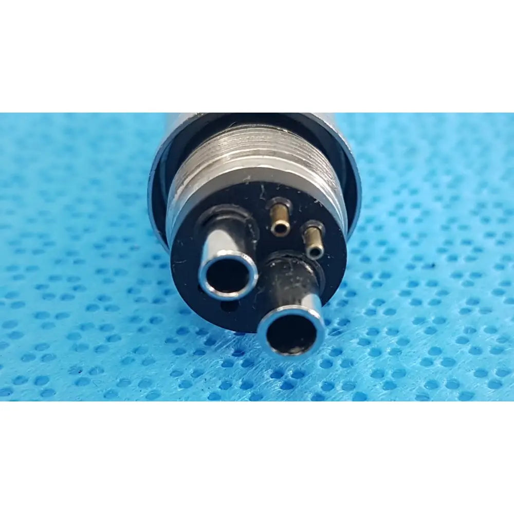 Silver and black w&h handpiece coupler dental connector with three metallic ports for high-speed handpieces back side view