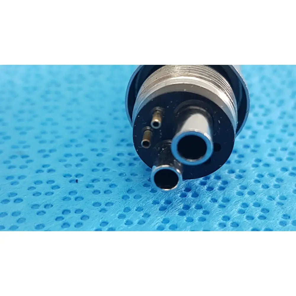 Silver metallic w&h handpiece coupler dental connector with three cylindrical ports and threaded collar for high-speed use