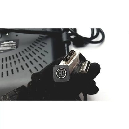 Black-gloved hand holding white silver dvi to usb adapter with 4-pin connector for wacom cintiq 21ux graphics monitor