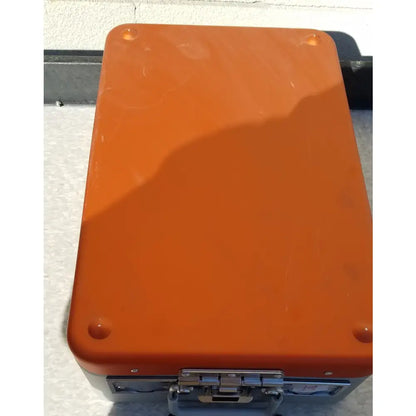 Orange hard-shell wagner steriset storage container with silver metal latches and corners for sterilization use