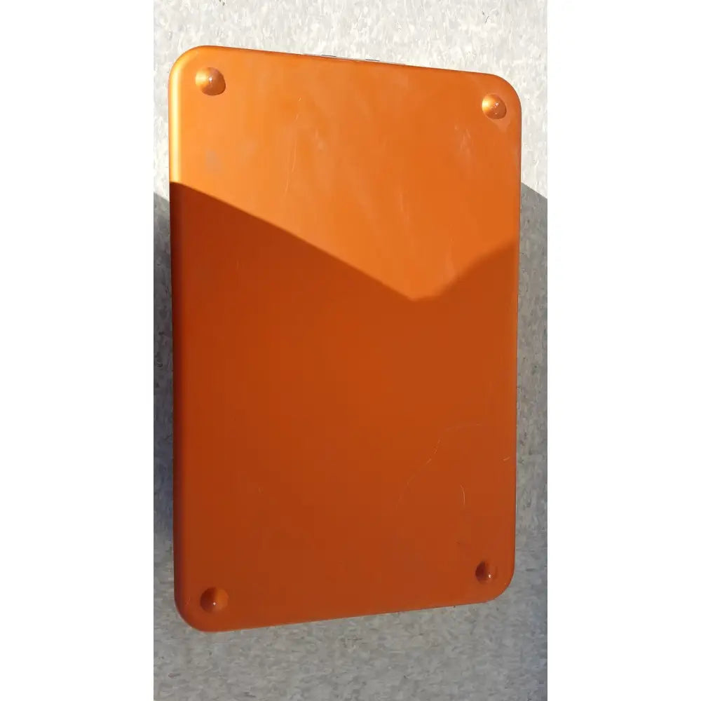 Orange rectangular plaque with rounded corners and four fasteners on wagner steriset storage container