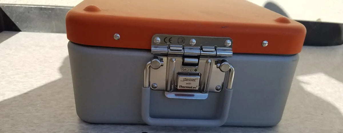 Gray and orange Wagner Steriset storage hard-shell toolbox with silver metal latch and handle branded thermal-ed