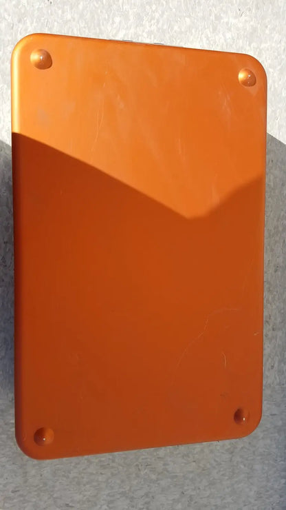 Orange rectangular plaque with rounded corners and four fasteners on wagner steriset storage container