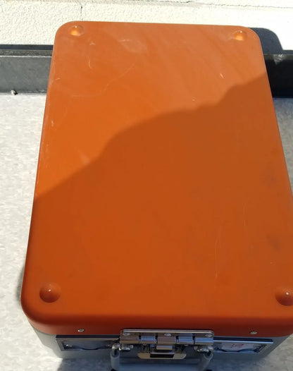 Orange hard-shell wagner steriset storage container with silver metal latches and corners for sterilization use