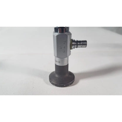 Silver and black industrial gas valve with hexagonal body engraved Germany and model number 0410 for reuse medical degree scope