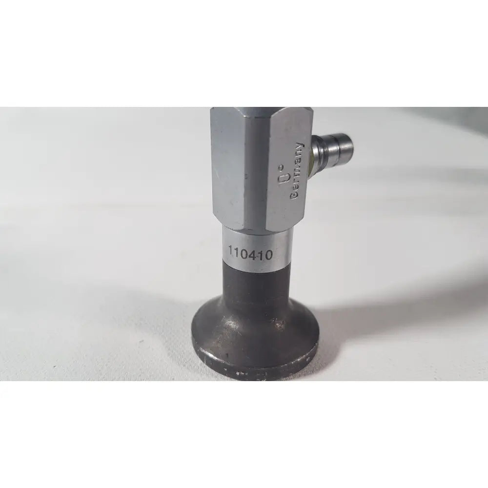 Silver-colored hexagonal valve with black base and stamped markings on the back side of weck 110410 0 degree scope for reuse medical use