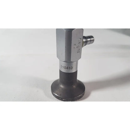 Silver-colored hexagonal valve with black base and stamped markings on the back side of weck 110410 0 degree scope for reuse medical use