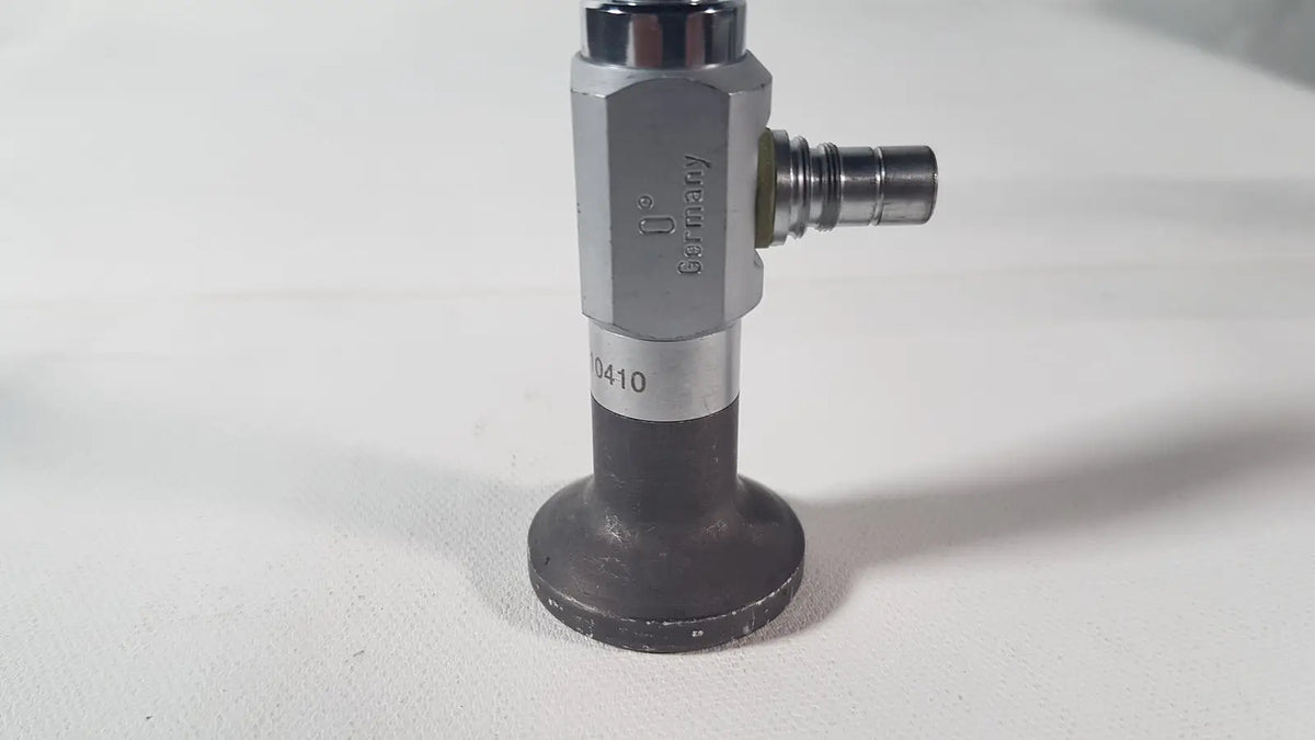 Silver and black industrial gas valve with hexagonal body engraved Germany and model number 0410 for reuse medical degree scope
