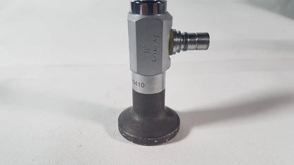 Silver and black industrial gas valve with hexagonal body engraved Germany and model number 0410 for reuse medical degree scope