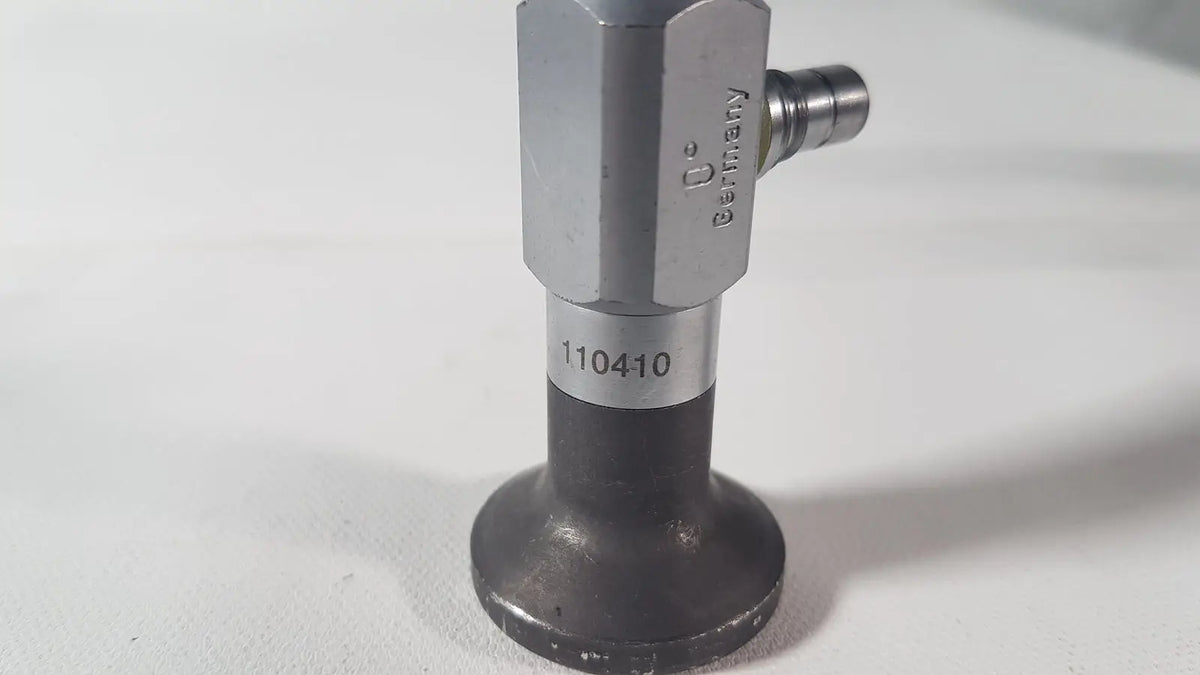 Silver-colored hexagonal valve with black base and stamped markings on the back side of weck 110410 0 degree scope for reuse medical use