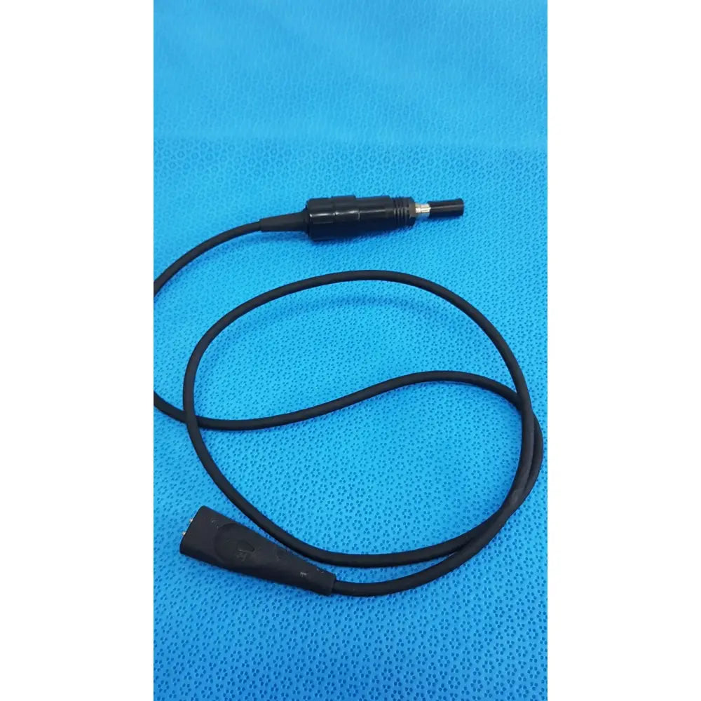 Black coiled welch allyn illuminator bulb cable with textured grip and metallic tip connectors for medical lighting use