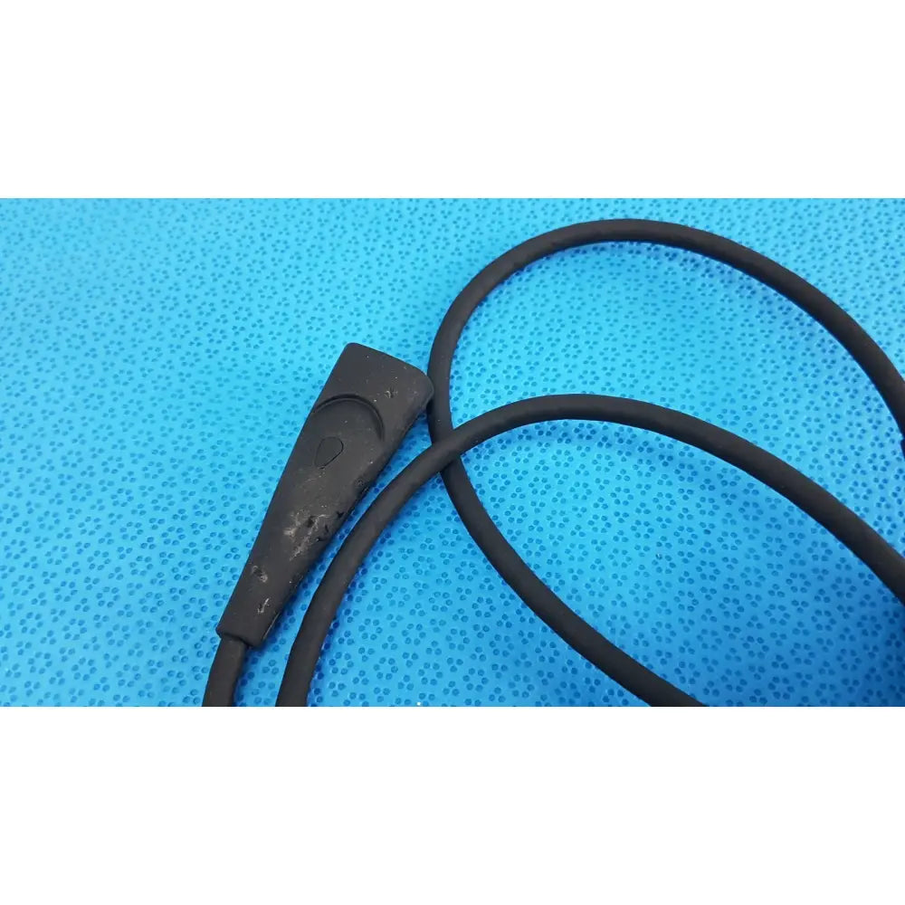 Black rubber-coated welch allyn illuminator bulb cable with a rectangular connector and circular indentation for medical use