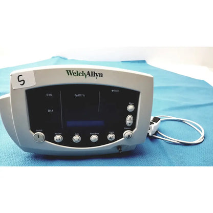 Welch allyn 300 series vital signs monitor with sleek gray pulse oximeter casing and black display showing readings