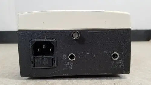 Welch Allyn 48740 exam light power supply unit black and beige rectangular with ac input port on left side back view